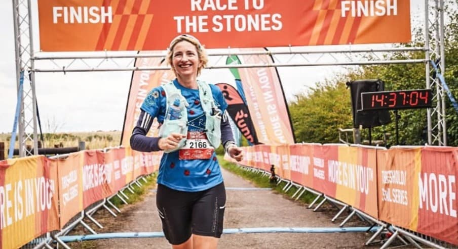 A Race to the Stones runner crossing the finish line after 100km